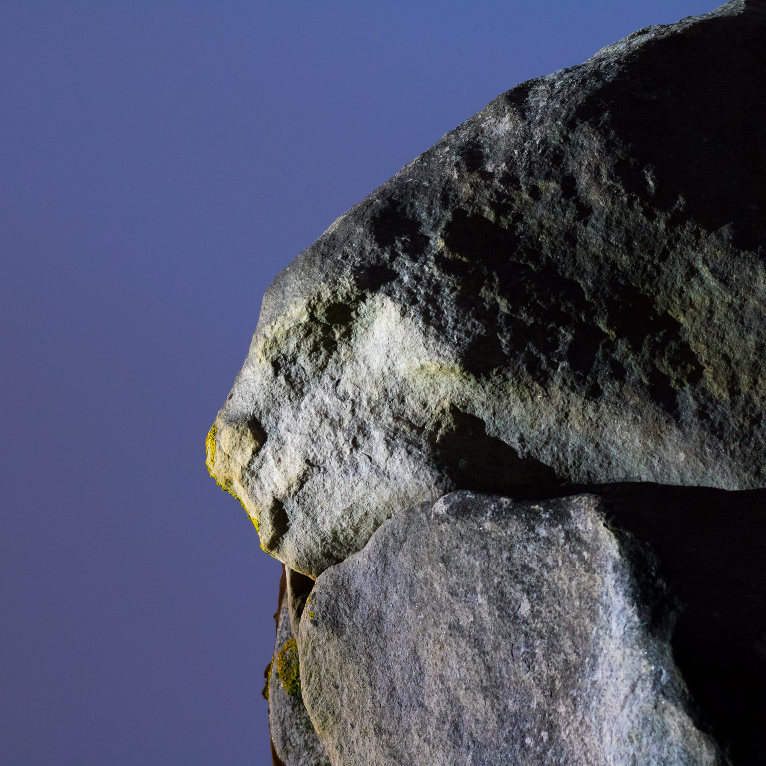 Night image of left looking stone animal at Avebury Henge